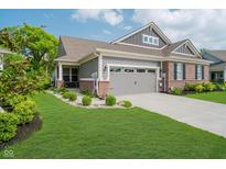 Beautiful two-story home features a brick and gray exterior, well-manicured lawn, and attached two-car garage at 5020 Eldon Dr, Noblesville, IN 46062
