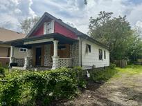 Craftsman-style home needing renovation, featuring a front porch and distinct architectural details at 528 N Dearborn St, Indianapolis, IN 46201
