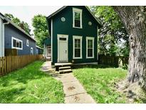 Charming two-story home with a well-manicured lawn and inviting front entrance at 631 Prospect St, Indianapolis, IN 46203