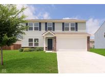 Charming two-story home with light siding, a well-maintained lawn, and a two-car garage at 6410 Avacado Dr, Indianapolis, IN 46217