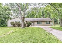 Ranch style home with mature trees and landscaping at 7503 Grandview Dr, Indianapolis, IN 46260