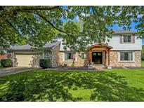 Charming two-story home with stone accents, mature trees, and a well-maintained lawn at 781 Dayton Dr, Carmel, IN 46033