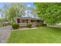 Charming single-story home with a well-maintained lawn and a red trim, offering great curb appeal at 7835 E 50Th St, Indianapolis, IN 46226
