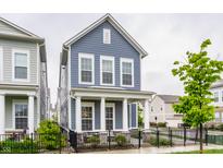 Charming two-story home featuring a welcoming front porch with classic white columns and a well-manicured front yard at 965 Astor Ln, Carmel, IN 46032