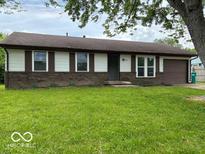 Charming single-story home with a well-maintained front yard and a classic brick facade at 1002 Brookside Ln, Plainfield, IN 46168