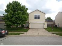Charming two-story home with a well-maintained front yard and a two-car garage at 10795 Albertson Dr, Indianapolis, IN 46231