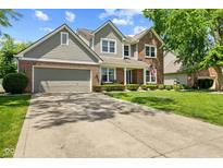 Charming two-story home featuring a well-manicured lawn and attached two car garage at 10988 Eaton Ct, Fishers, IN 46038