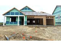 New construction home with visible framework, showcasing modern design, open garage, and potential for a stunning residence at 1351 Foxtail Ln, Greenwood, IN 46143