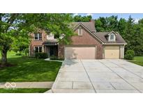Charming two-story brick home with a spacious driveway and well-maintained lawn at 14814 Beacon Blvd, Carmel, IN 46032