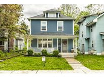 Charming two-story home with blue siding, white trim, front porch, and well-maintained lawn at 3047 N New Jersey St, Indianapolis, IN 46205