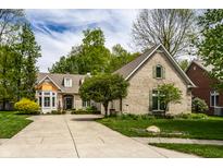 Charming brick home with manicured lawn, mature trees, and a spacious driveway at 3556 Towne Dr, Carmel, IN 46032