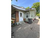 Charming single-story home with brick accents, front porch, and a detached garage in the backyard at 3646 Creston Dr, Indianapolis, IN 46222