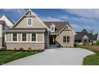 Charming home with a brick and siding exterior, complemented by a well-manicured lawn and a concrete driveway at 4190 Hartswick Ct, Zionsville, IN 46077
