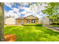 Charming home with inviting front porch, manicured lawn, and lush greenery at 433 N 15Th Ave, Beech Grove, IN 46107