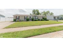 Charming single-story home featuring manicured lawn and mature landscaping at 4641 Autumn Ridge Dr, Columbus, IN 47203