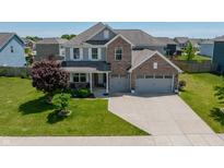 Beautiful two-story home featuring a brick facade, three-car garage, and well-maintained landscaping at 4863 Sherlock Dr, Westfield, IN 46062