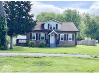 Charming two-story home featuring a well-maintained lawn and classic architectural details at 4943 S State Ave, Indianapolis, IN 46227