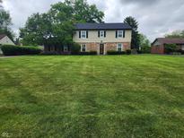 Beautiful two-story home with a brick and siding exterior and expansive green lawn at 5433 Brendonridge Rd, Indianapolis, IN 46226