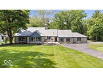Charming single-story home featuring a beautifully landscaped yard and inviting curb appeal at 8100 N Meridian St, Indianapolis, IN 46260