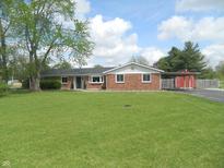 Charming brick ranch-style home with a spacious front yard and mature trees at 833 N 700 W, Greenfield, IN 46140