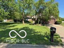 Charming home featuring a spacious front yard, mature trees, and a classic mailbox at 8835 Winding Ridge Rd, Indianapolis, IN 46217