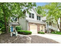 Charming two-story home featuring brick accents, a two-car garage, and landscaped front yard at 1030 Longwell Pl, Indianapolis, IN 46240