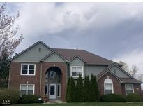 Charming two-story home boasts brick and siding exterior with a well-manicured front lawn at 11458 Sutton Place W Dr, Carmel, IN 46032