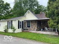 Inviting home featuring stone accents on the porch, complemented by a well-maintained lawn and mature trees at 121 W Fordice St, Lebanon, IN 46052