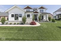 Charming two-story home boasting a manicured lawn, stone accents, and tasteful landscaping elements at 14464 Gainesway Cir, Fishers, IN 46040
