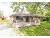 Charming brick home with a covered front porch and well-maintained lawn at 156 N Eastern Village Dr, Greenfield, IN 46140