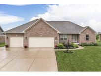Charming brick home with a well-manicured lawn, a two-car garage and a welcoming entrance at 1751 S Centennial Ave, New Palestine, IN 46163