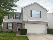 Inviting two-story home with a well-manicured lawn and attached two-car garage at 1774 Blue Grass Pkwy, Greenwood, IN 46143