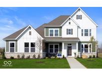 Charming two-story home with a mix of white and green siding, complemented by a well-manicured lawn and stone accents at 19848 Chatsworth Blvd, Westfield, IN 46074