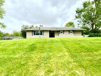 Charming single-story home on a well-manicured, sloping front lawn at 2221 E 35Th St, Anderson, IN 46013