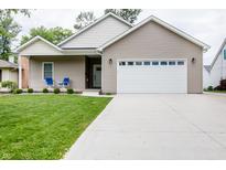 Charming single-story home featuring a well-manicured lawn and a two-car garage at 2686 Lafayette Ave, Columbus, IN 47201