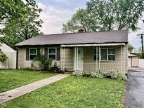 Charming home featuring a well-maintained lawn, covered porch, and neutral siding at 3645 Winings Ave, Indianapolis, IN 46221