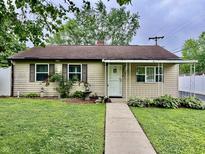 Charming single-story home featuring well-manicured landscaping and a welcoming covered porch at 3645 Winings Ave, Indianapolis, IN 46221