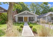 Charming single-story home features a covered front porch, gray siding, and a well-manicured lawn at 4359 Winthrop Ave, Indianapolis, IN 46205
