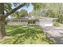 Charming single-story home featuring a well-maintained lawn and attached garage at 4622 S Franklin Rd, Indianapolis, IN 46239