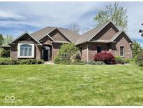 Charming brick home with well-manicured lawn and mature landscaping offers great curb appeal at 5200 W Shoreline Ter, Muncie, IN 47304