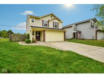 Charming two-story home features a well-manicured lawn, brick accents, and an attached two-car garage at 5361 Cradle River Ct, Indianapolis, IN 46221
