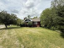 Charming brick home with a well-maintained lawn and mature trees, offering great curb appeal at 5960 Southeastern Ave, Indianapolis, IN 46203