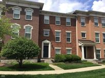 Attractive brick townhouse with well-maintained lawn and inviting front entrance at 6304 El Paso St, Whitestown, IN 46075