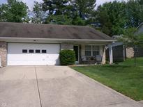 Single-story home featuring a lush lawn, front seating, and attached garage and long driveway at 6723 S New Jersey St, Indianapolis, IN 46227