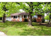 Charming brick ranch-style home with attached garage and well-maintained front yard at 706 Bobs Ct, Beech Grove, IN 46107
