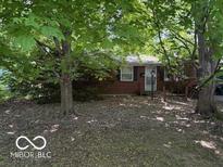 Cozy brick home with mature trees and a well-maintained front yard at 7141 E 48Th St, Indianapolis, IN 46226