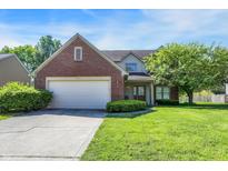 Charming two-story home featuring brick accents, attached garage, and well-manicured lawn at 7587 Winding Way, Fishers, IN 46038