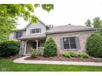 Charming two-story home with a brick facade, gray shutters, and a well-manicured front yard at 9127 Pointe Ct, Fishers, IN 46037