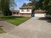 Charming two-story home features an attached garage and a well-maintained front yard at 9210 Brantford Ct, Indianapolis, IN 46260