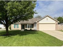 Charming single-story home with well-manicured lawn and attached two-car garage at 948 Kitner Ave, Avon, IN 46123